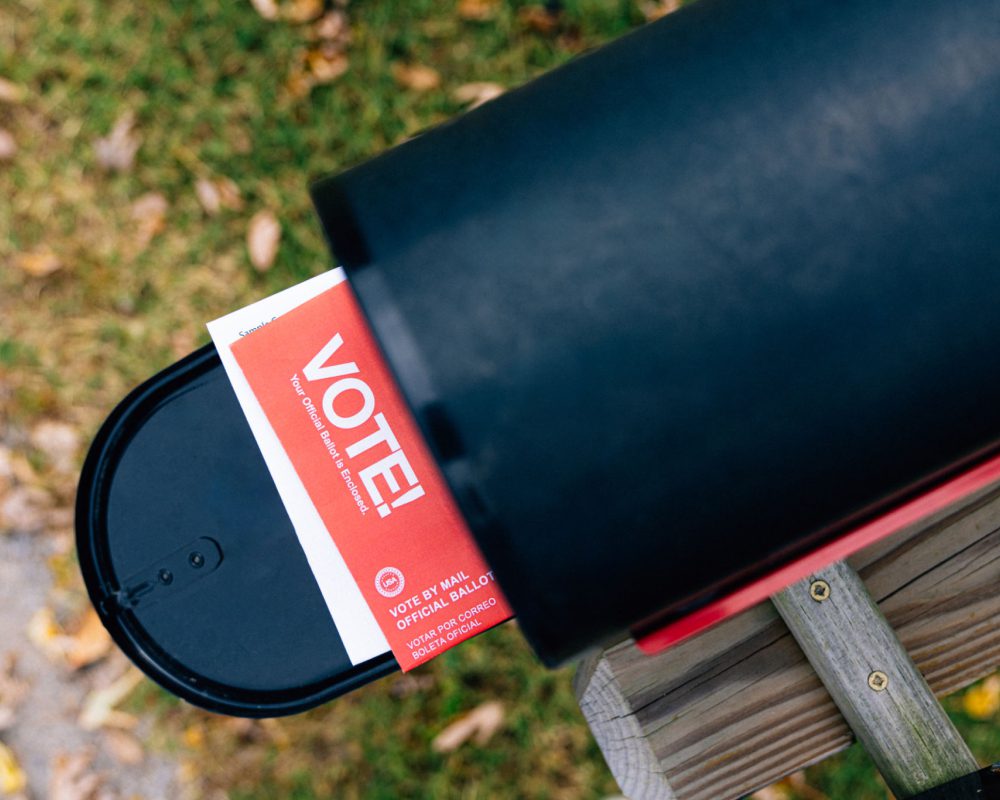 Mail-in ballot in a black mailbox.