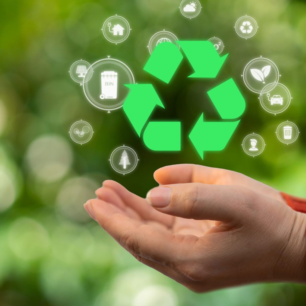 Hand holding recycling symbol with icons.